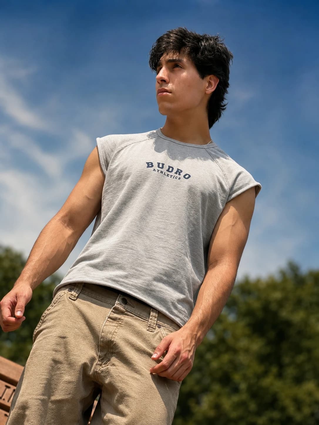 Low-angle portrait wearing a gray Budro Athletics shirt outdoors